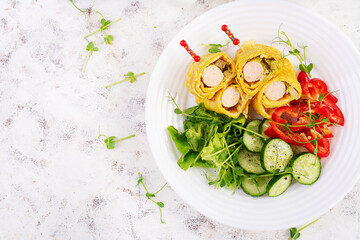 Ketogenic breakfast. Omelette with sausage. Sausage roll in omelette with lavash. Keto, ketogenic lunch. Top view
