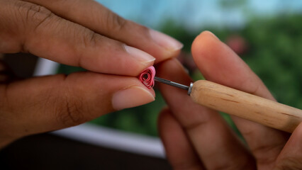 Crafting with Care: Close-Up of Woman's Hand Quilling Paper