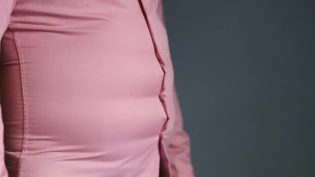 Closeup footage of overweight man try to sexy, over size and fat body wearing clothes concept, 4K 25fps hight resolution video