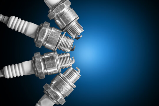 Spark plugs on blue gradient background