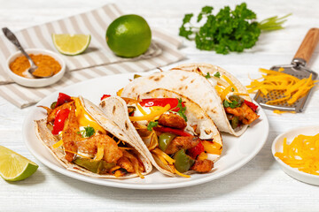 baked tex-mex chicken fajitas on a plate, top view