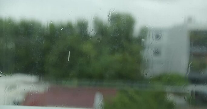 Rain drops window. Large rain drops strike a window pane during a summer shower. Water droplets on glass, Go Away. rain drops.4K