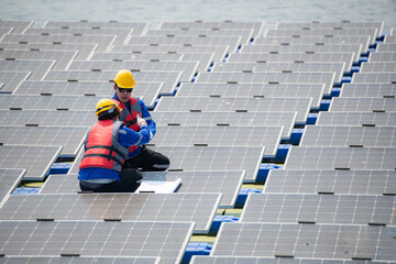 Photovoltaic engineers work on floating photovoltaics. Inspect and repair the solar panel equipment floating on the water.