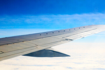 Fototapeta premium Beautiful view of the wing of an airplane high in the sky.