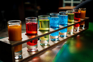 Variation of hard alcoholic shots served on bar counter.