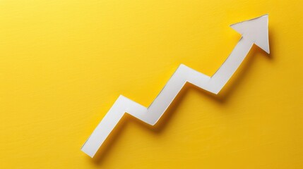 Right-up arrow cutted from solid sheet of yellow paper and curved up of one side with white paper underlay showing growth of stock market or up direction