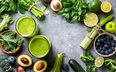 Poster Green fruits and leafy vegetables smoothies in two glasses, green vitamin drink for detox and getting skinny diet © Mirela