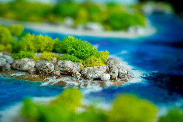 The process of making the art decor of epoxy resin, natural stones and moss