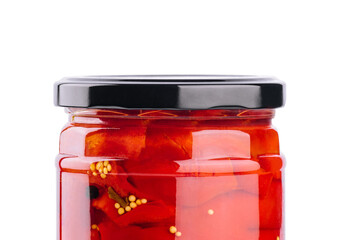 Sweet red peppers in a glass jar isolated on a white background