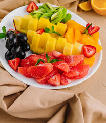 assorted sliced tropical fruits on plate