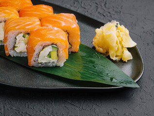 Fresh delicious philadelphia sushi on black plate