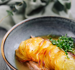 Baked potato slices gratin with meat