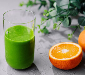 Freshly made spinach smoothie and orange