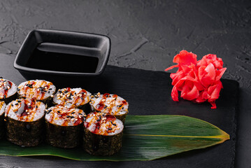 Traditional fresh japanese sushi futomaki on black stone