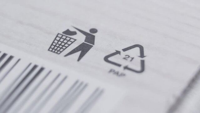 Recycling signs and others on white packaging. Recycled material sign. PAP sign depicted on packages of products. Close-up in 4K, UHD