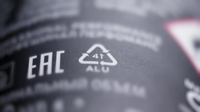 Sign and symbol of recycling on black packaging. Concept of recycling, ecology. ALU 41. Aluminum packaging Environment protection. Close-up in 4K, UHD