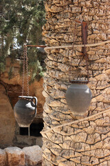 Old clay jugs hanging on a palm tree in Bethlehem, Israel