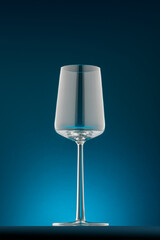 An elegant wine glass in beautiful light with blue background