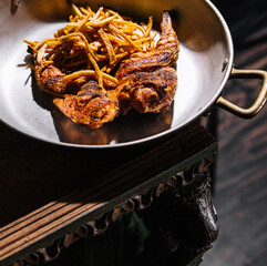 Fried chicken leg with french fries on pan