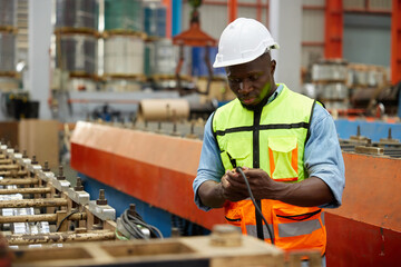 worker or engineer operating remote switch to control machine in the factory