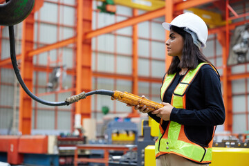 worker or engineer operating remote switch to control machine in the factory