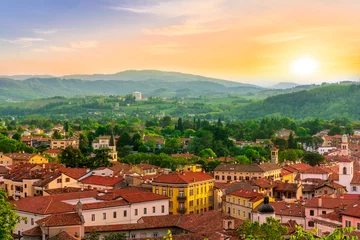 Foto op Canvas travel summer view from hill to a nice european town with amazing buildings, green hills and mountains with amazing cloudy evening sky on background © Yaroslav