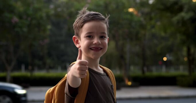 Cute child shows thumbs up gesture, happy facial expression emotion glad smiling face. Portrait Funny kid little boy smiling child looking at camera. Pretty face child. Concept of a happy childhood.4K