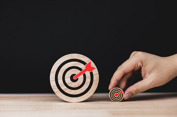 Determination and success. Two wooden circles with target icons of different sizes. concepts of...