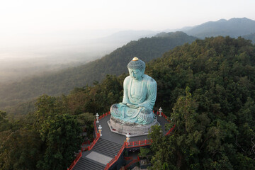 Aerial view of The Great Buddha at Doi Phra Chan is a towering bronze Buddha statue that can be reached by climbing 628 steps up at wat Prathat Doi Prachan, Pa Tan, Mae Tha District, Lampang, Thailand