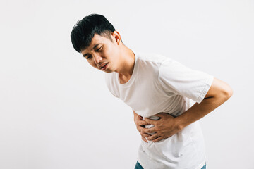 A portrait of a man in pain, experiencing stomachache and digestive distress. Studio shot isolated on white background, illustrating health and medical concerns.