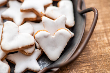 Cinnamon cookies for Christmas, in the shape of hearts and stars