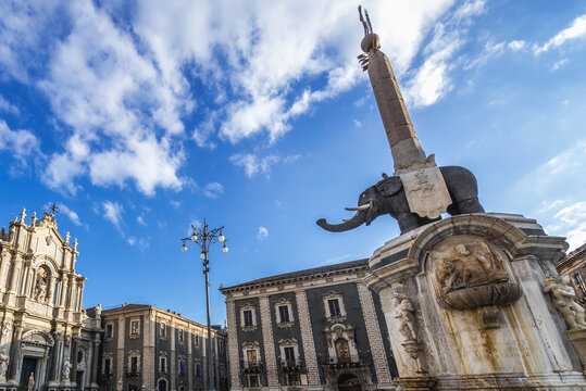 Catania, Italy - December 16, 2016: Elephant Fountain and Cathedral of St Agatha in historic part of Catania city, Sicily