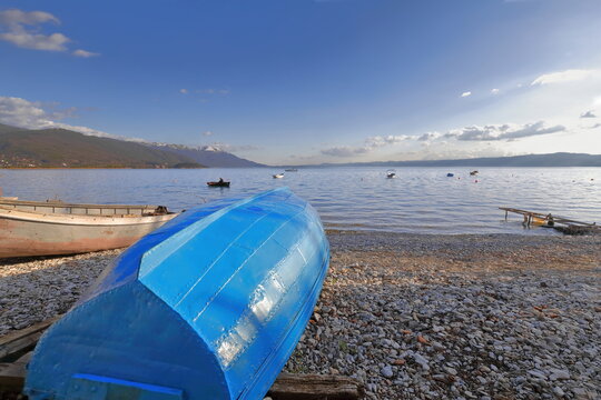 Vernacular rowboats aground on the shore, pebble Saraiste beach on the lakeside along Kosta Abrash street. Ohrid-North Macedonia-330