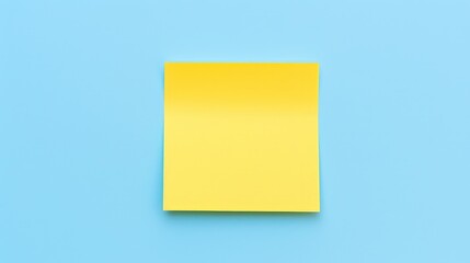 Yellow sticky note on blue background. Top view with copy space.