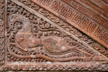 Closeup view of carved terracotta mythological horselike creature on exterior wall of ancient Chota Anhik hindu temple, Puthia, Rajshahi, Bangladesh