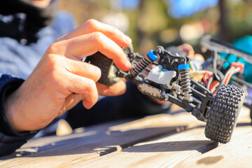 Child playing with a remote-controlled gas-powered toy car