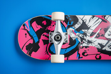 an upside down skateboard sitting on a blue background with a white skateboard attached