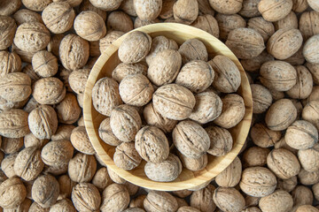Walnut in shell. Background view from above. Healthy food bowl top view