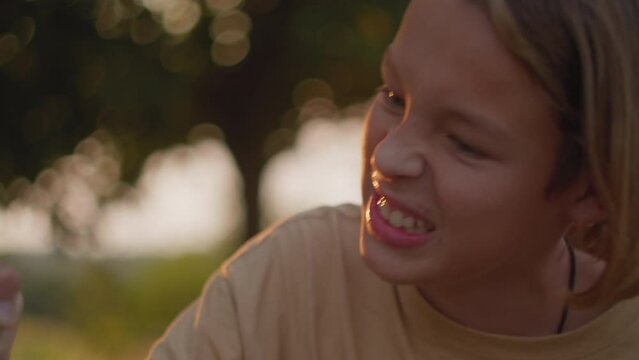 Close up of two teenagers engaged in arm wrestling outdoors