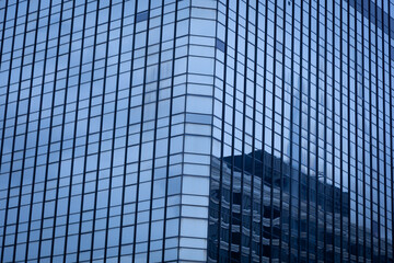 The modern building in the business district has glass windows to let in the light.