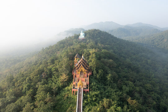Aerial view of  Wat Pra That Doi Pra Chan and Great Buddha at Doi Phra Chan is a towering bronze Buddha statue that can be reached by climbing 628 steps up, Pa Tan, Mae Tha District, Lampang, Thailand