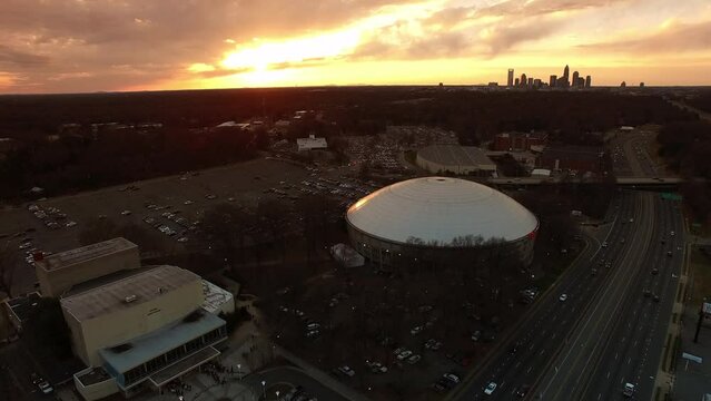 Aerial Shot Of Bojangles Coliseum In Modern City, Drone Flying Backwards During Sunset - Charlotte, North Carolina