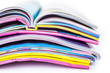 Pile of colorful magazines isolated over white background.