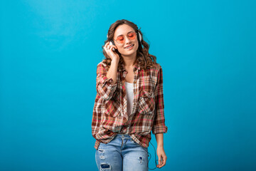 attractive woman in cheerful exited mood listening to music in headphones