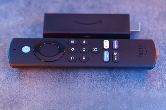 Milan, Italy - January 28, 2024: close up on Amazon Fire Stick Tv device and remote controller for tv streaming.