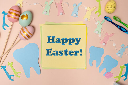 Greeting card for dentistry happy Easter text, tooth, painted eggs and bunnies top view.