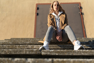 A beautiful young girl walks through the spring city.