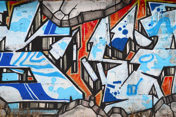 Colorful background of graffiti painting artwork with bright aerosol outlines on wall. Old school...