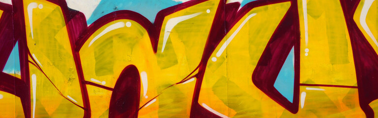 Colorful background of graffiti painting artwork with bright aerosol outlines on wall. Old school...