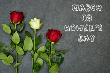 Fototapeta na wymiar beautiful rose flower on gray grunge background with happy women's day
